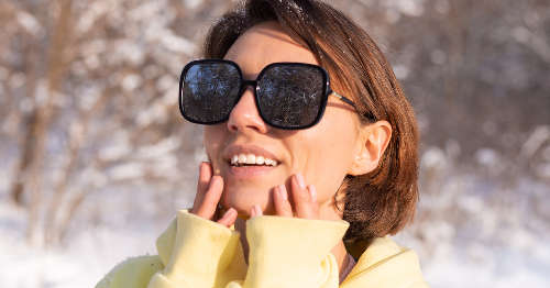 Mujer con gafas de sol para proteger la piel en invierno