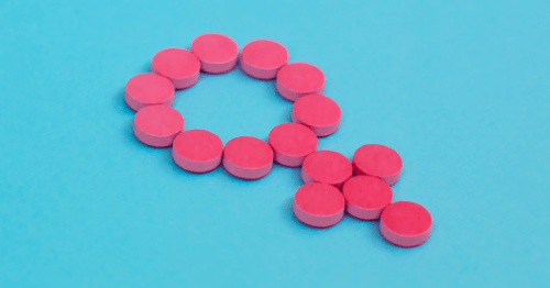 Pastillas hormonales formando el símbolo de la mujer